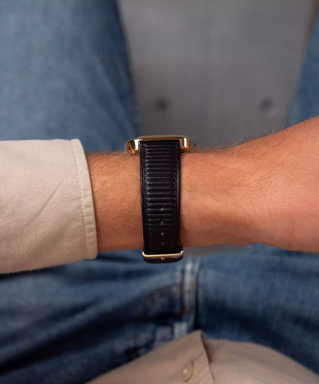 Close-up of the ribbed black strap of an Adidas AOSY24528 watch worn on a wrist.