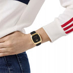 Adidas AOSY24528 watch worn on a wrist beside a white sleeve with red stripes.
