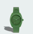 Front view of Adidas AOST24053 watch with a green dial, case and strap casting a shadow on a pale background.