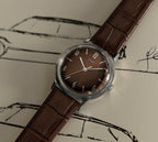 front view of Timex Mens Watch Marlin Hand Wound TW2W93300 with brown dial, leather strap and silver case laid out flat